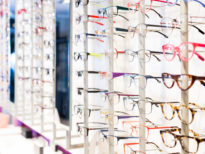 Image of glasses showcase in modern optic shop, nobody